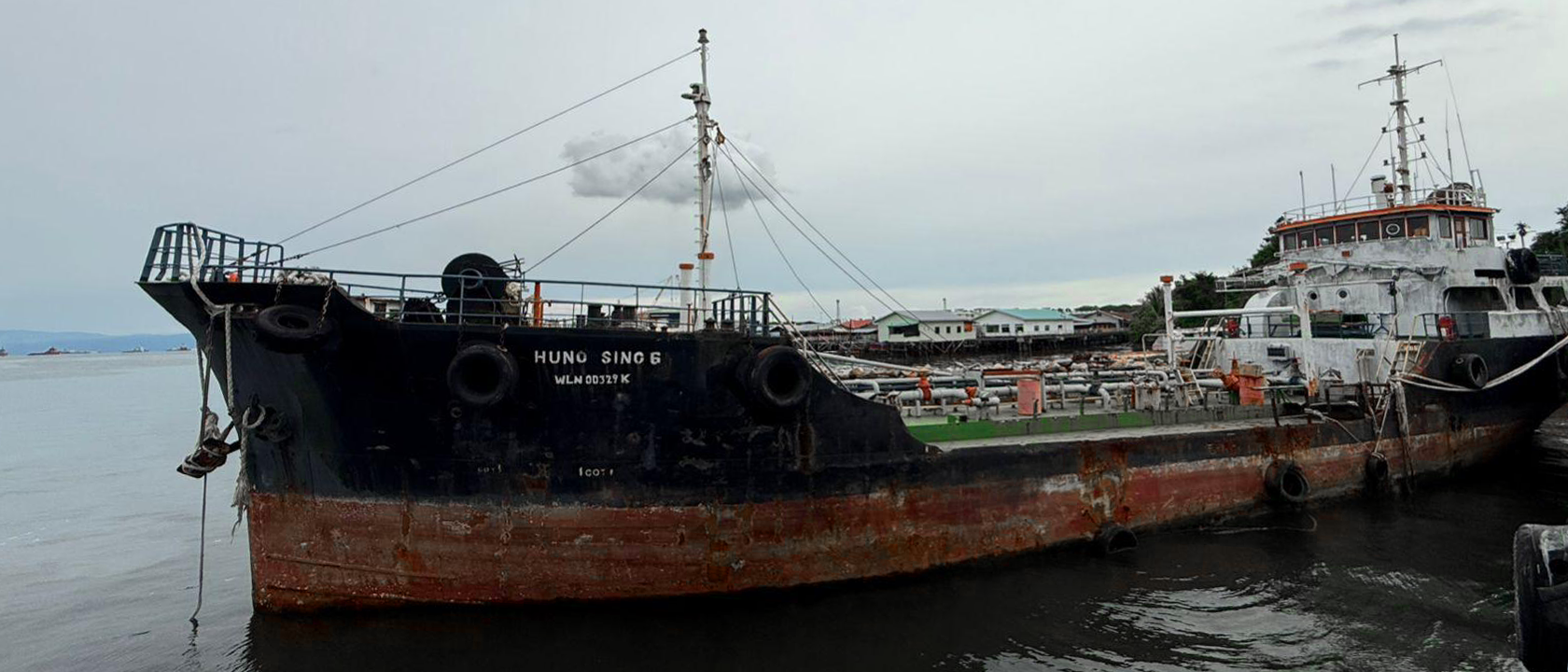 Aerial view of large ships docked at a port at night.
